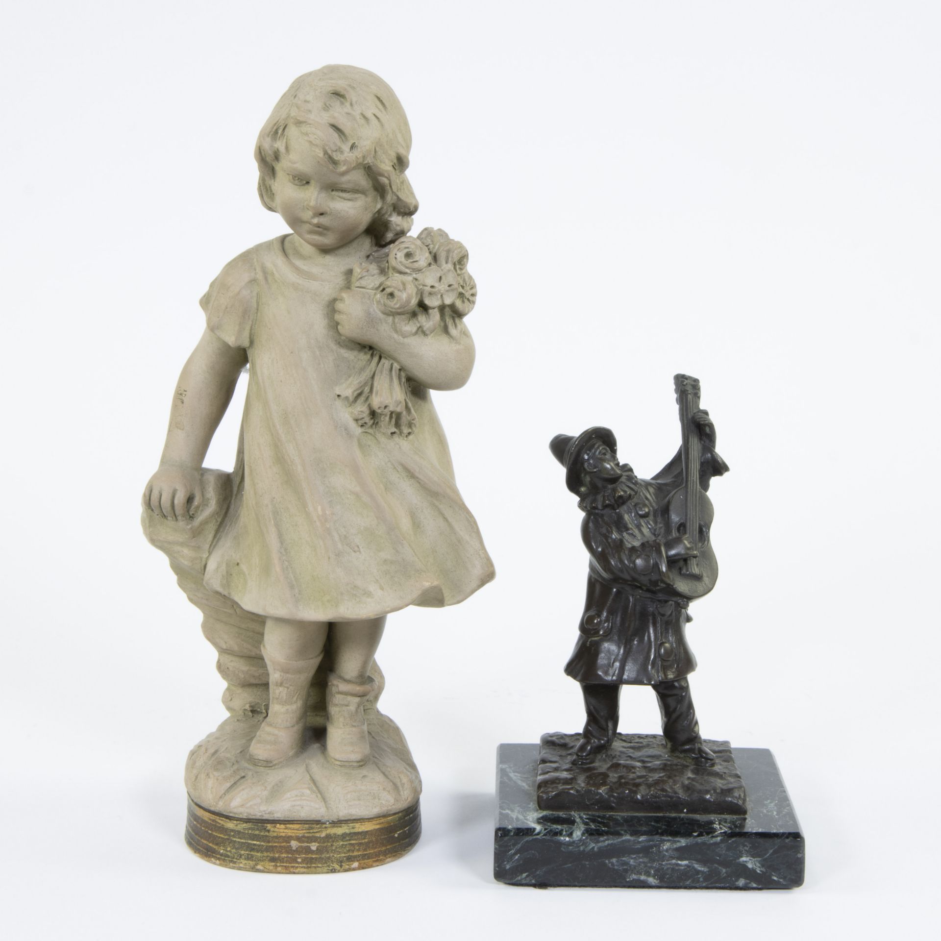 Collection of a bronze in black patina The musician, signed Rousseau and a terracotta figurine Flowe
