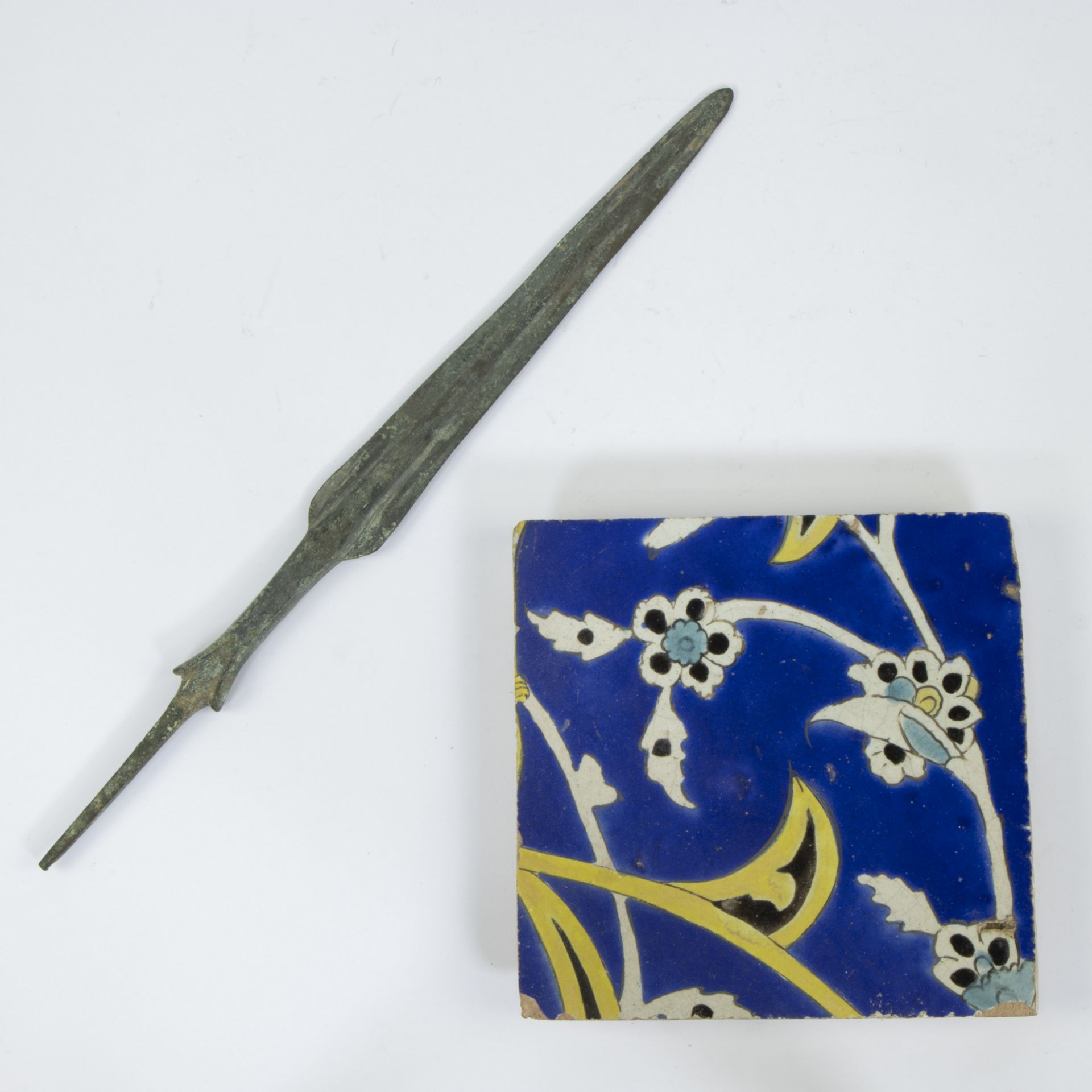 Iranian tile from Isfahan mosque (1967 demolition) and bronze spearhead Lorestan