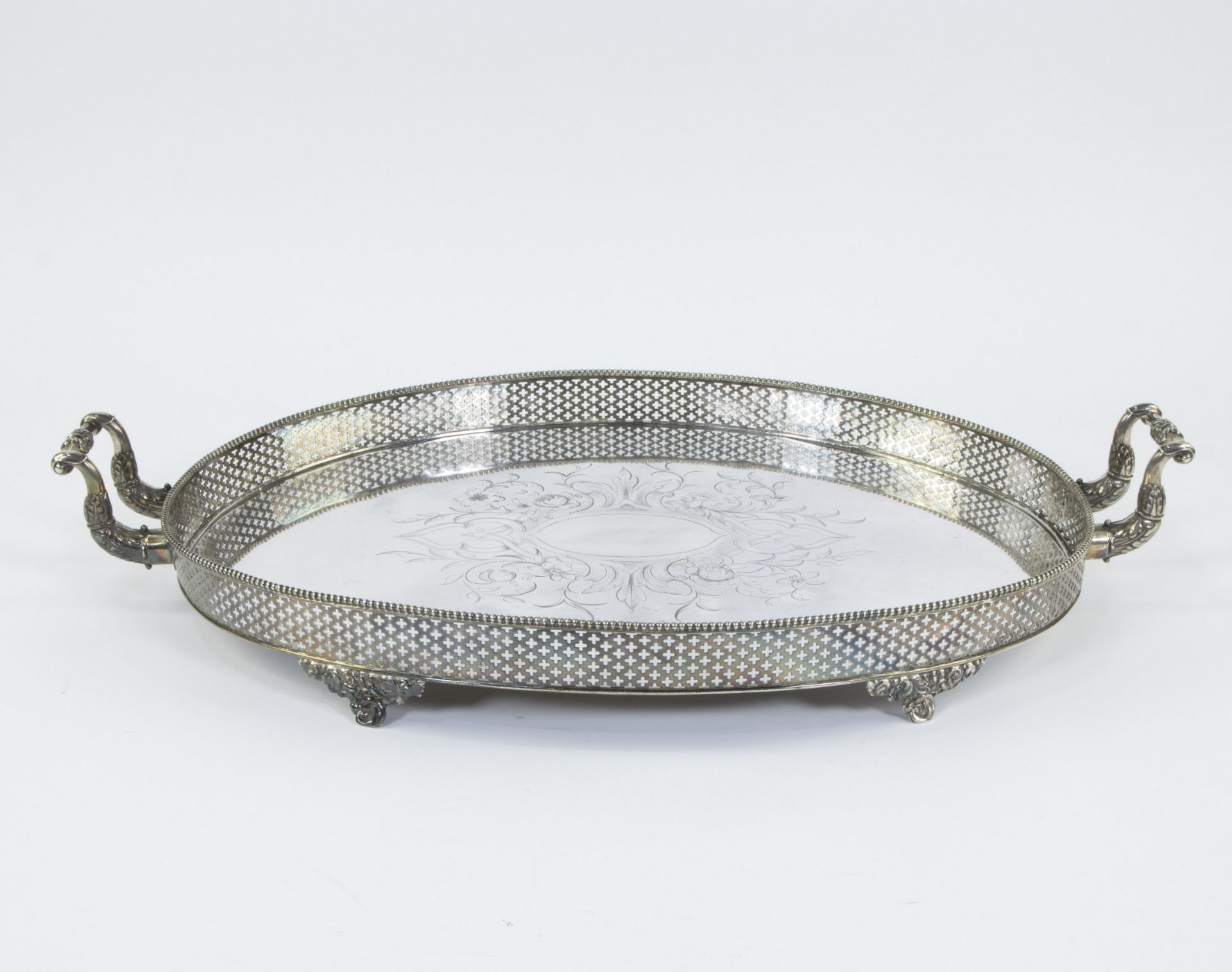 Large silver serving dish with central hand-engraved motif and finely perforated rim in the shape of