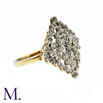 A Diamond Dress Ring in yellow and white gold, the central diamond-set floral motif further accented