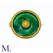 A Jade Brooch in yellow gold, the jade disc with Chinese Character to the centre is set within a