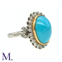 A Turquoise and Diamond Cluster Ring in platinum and yellow gold, the central large turquoise