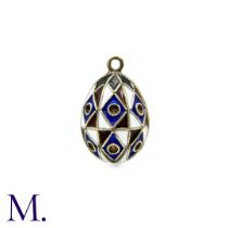An Enamelled Egg Pendant with red, white, blue and black enamel. No markings visible. Size: 2.3x1.