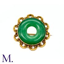 A Jade Brooch in 15k yellow gold, the central jade disc set to a scalloped edge gold border. Stamped