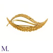 NO RESERVE - A Gold Foliate Brooch. The 9ct gold yellow brooch is shaped as a leaf with textured