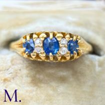 An Antique Sapphire and Diamond Ring in 18k yellow gold, the three principal round cut sapphires
