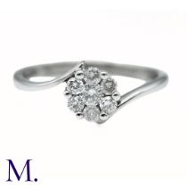 A Diamond Cluster ring in 9k white gold, the central cluster of seven round cut diamonds to a