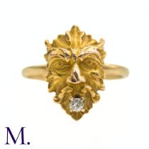 A Diamond 'Green Man' Ring in yellow gold, in the form of the 'Green Man' set to the mouth with a