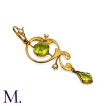 An Antique Peridot Pendant in yellow gold, designed as a central cushion cut peridot accented by