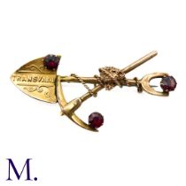 A South African Garnet-Set Prospector/Digger Brooch in yellow gold, designed as a crossed spade