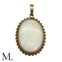 An Antique Opal Pendant in yellow gold, the large cabochon opal framed within a gold rope-work