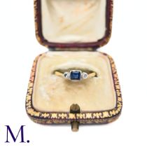 A Sapphire and Diamond Three Stone Ring in 18k yellow gold and platinum, the central square step cut