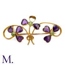 An Antique Amethyst and Peridot Suffragette Brooch, designed as a trio of shamrocks to a scrolling