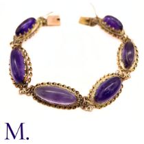 An Antique Amethyst Bracelet in yellow gold, set with six elongated cabochon amethyst each set