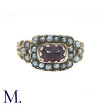 An Antique Garnet and Pearl Memorial Ring in yellow gold, the central elongated cushion cut garnet