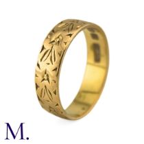 A Gold Band in 22k yellow gold, the 5mm band engraved with foliate decoration. Hallmarks for 22ct