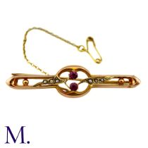 A Ruby And Pearl Brooch in 9k yellow gold, centrally set with two round cut rubies, with pearl set