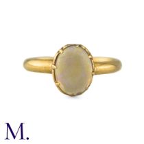 An Antique Opal Ring the central cabochon opal claw set to a gold band. (Unmarked but tests indicate