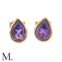 A Pair Of Amethyst Stud Earrings in 9k yellow gold, comprising two collet set pear shaped amethysts.