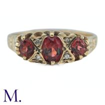 A Garnet and Diamond Ring, in 9k yellow gold, the three oval cut Garnets punctuated by pairs of