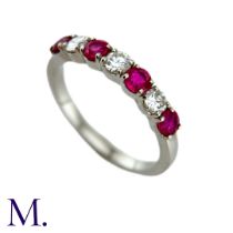 A Ruby And Diamond Seven Stone Ring in platinum, set with an alternating row of four round cut