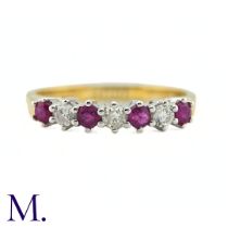 A Ruby And Diamond Seven Stone Ring in 18k yellow gold, set with a row of alternating rubies and