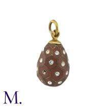 An Enamelled Egg Pendant, with brown enamel, set with white paste stones. Marks indistinct. Size: