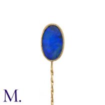 An Opal Doublet Stick Pin, in yellow gold, the terminal set with a opal doublet of approximately