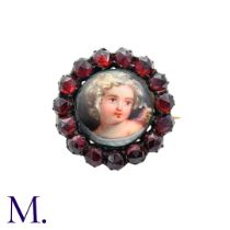 A Garnet And Enamel Brooch