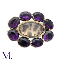 An Amethyst And Glass Brooch