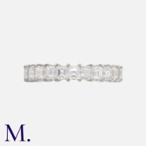A Diamond Half Eternity Ring in 18k white gold, set with a row of square step cut diamonds totalling