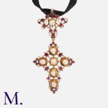 An Iberian Garnet and Pearl Cross Pendant in high carat gold, set with table cut garnets and natural