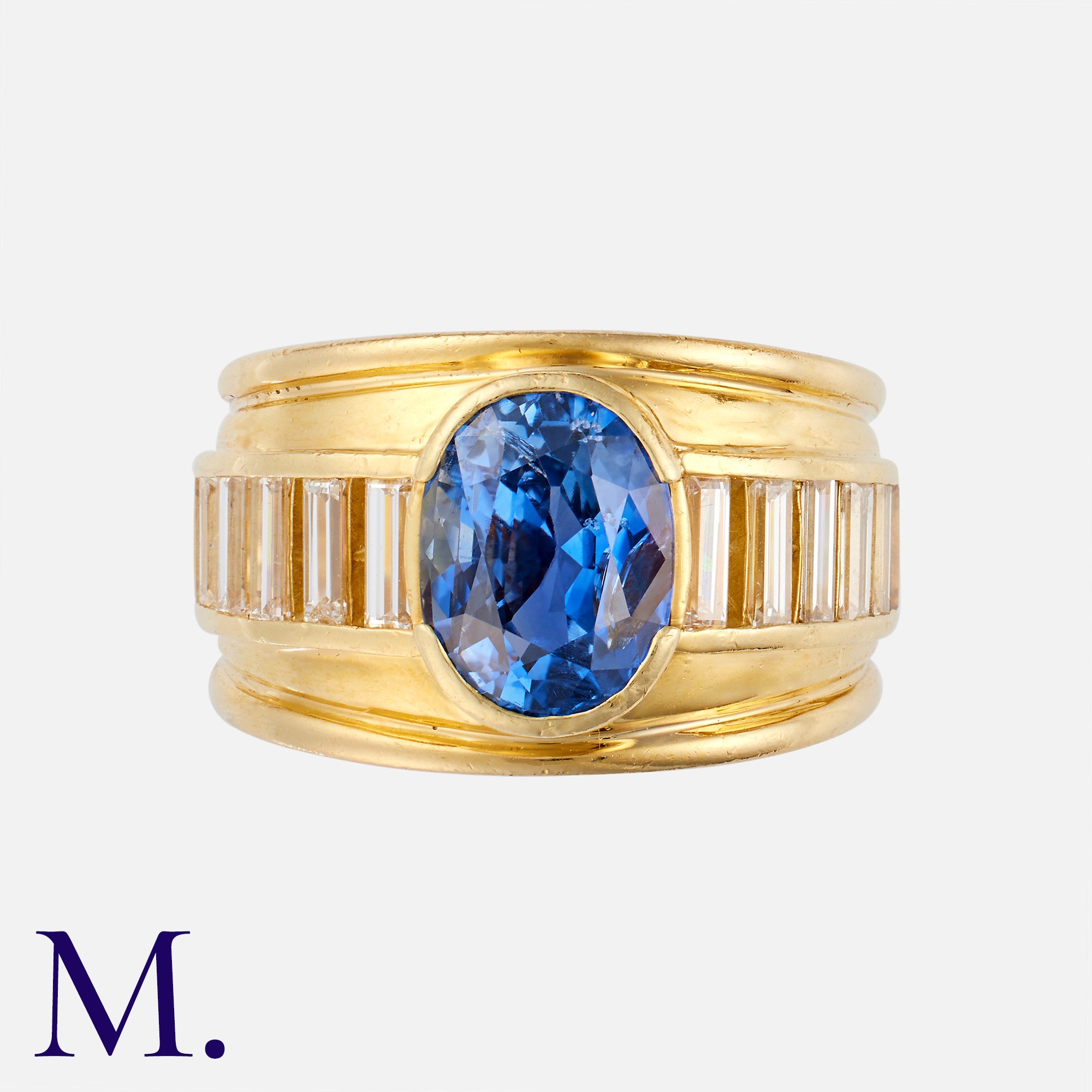 A Sapphire & Diamond Ring in 18K yellow gold, set with an oval-cut sapphire accompanied by a