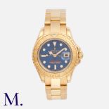 Rolex. A ladies Rolex Yacht Master, in 18ct yellow gold, the circular blue sunburst dial with