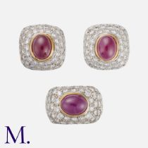 A Ruby and Diamond Earrings and Ring Set in 18K yellow gold. The ring, set with an oval cabochon