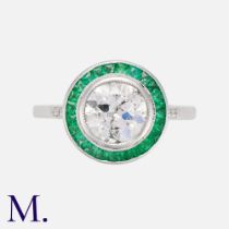 An Emerald & Diamond Target Ring in 18k white gold, set with a principal old cut diamond of