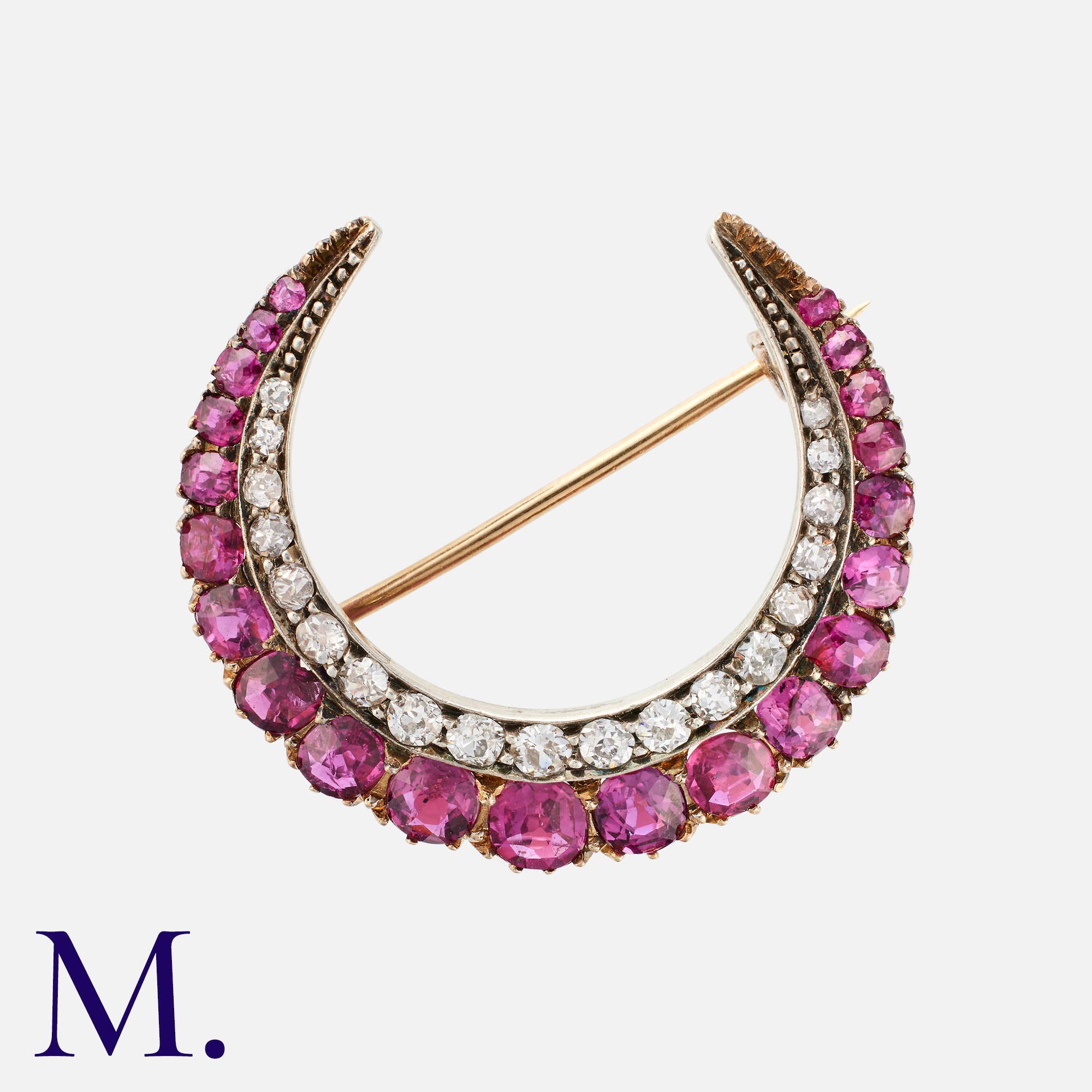 A Ruby And Diamond Crescent Brooch in yellow gold and silver, set with a row of rubies and a row