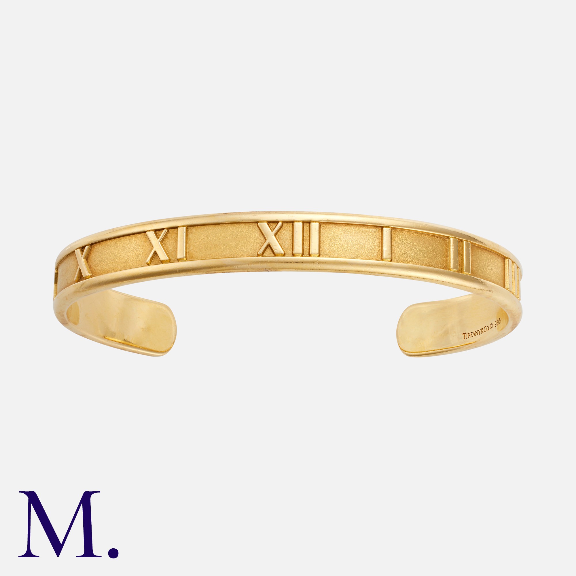TIFFANY & CO. An Atlas Bangle in 18K yellow gold, signed Tiffany & Co and marked for 18ct gold.