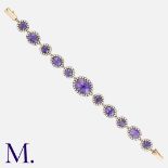 An Amethyst and Diamond Bracelet in gold and silver, set with faceted amethysts, the largest of