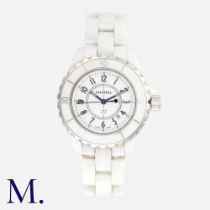 CHANEL. A Ladies Chanel J12 Wristwatch in white ceramic, quartz movement, the circular white