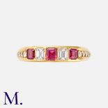 A Ruby & Diamond Ring in 18K yellow gold, set with three emerald cut rubies and two emerald cut