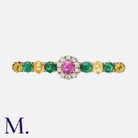 An Antique Diamond, Ruby, Emerald & Yellow Sapphire Brooch. The brooch is set with a ruby (