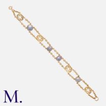 A Star Sapphire Bracelet in 18k yellow gold, comprising two rows of chain set with four cabochon