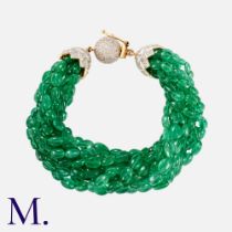 An Emerald & Diamond Bracelet in yellow gold, comprising nine rows of emerald beads totalling