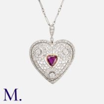 An Edwardian Ruby & Diamond Heart Pendant Necklace in platinum, the openwork form set with a