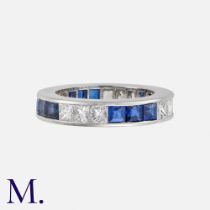 A Sapphire and Diamond Eternity Ring in 18k white gold, set with approximately 1.5ct princess cut
