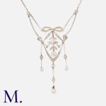 A Diamond & Pearl Pendant Necklace in 18k yellow and white gold, the openwork foliate and bow form