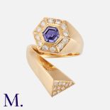 A Purple Sapphire & Diamond Ring in 18k yellow gold, the twisted style band set with a principal
