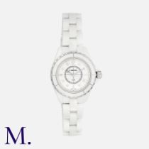 CHANEL. A Ladies Chanel J12 Diamond Wristwatch in white ceramic, quartz movement, the circular white