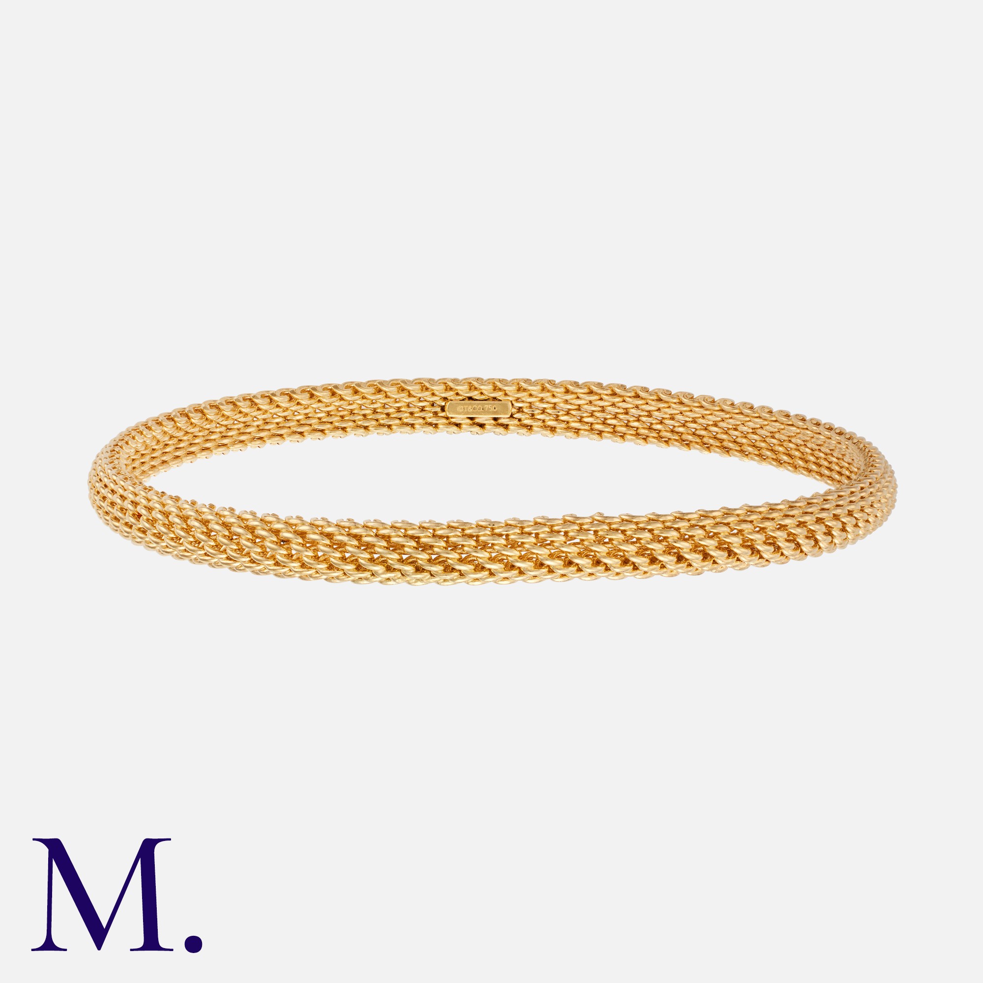TIFFANY & CO. A Gold Somerset Mesh Bangle in 18K yellow gold. The bangle is marked for 18ct gold and
